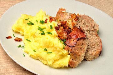 Pork chop with mashed potatoes, bacon and fresh chives