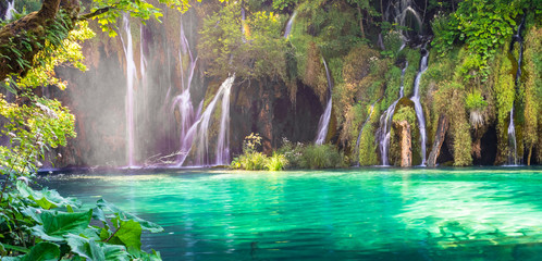 Panorama of waterfalls and turquoise colored water of Plitvice Lakes in Croatia