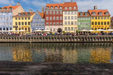 Obraz premium Famous Nyhavn pier with colorful facades of old houses and vintage ships in Copenhagen, capital of Denmark. Summertime in the fantastic city of Copenhagen