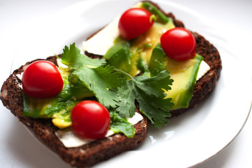 Breakfast rye bread sandwich with mozzarella and avocado