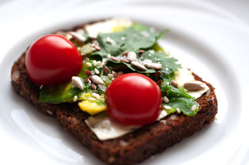 Breakfast rye bread sandwich with mozzarella and avocado