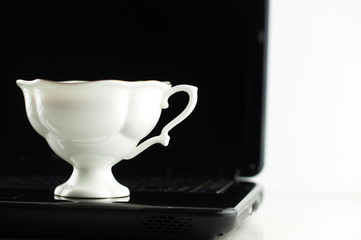 mug of coffee on the laptop keyboard