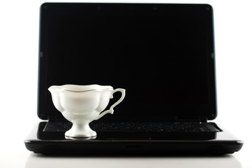 mug of coffee on the laptop keyboard