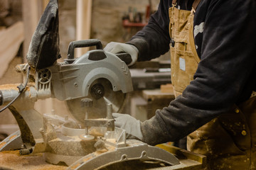 Carpenter using circular saw for wood