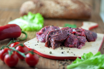 appetizing fresh meat with spices on a cutting Board