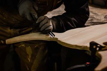 Carpenter using gouge for wood