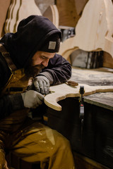 Carpenter using gouge for wood