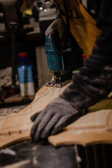 Carpenter using an electric jigsaw