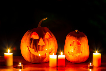 halloween night scene, pair of jack o lantern pumpkin with candle on the table