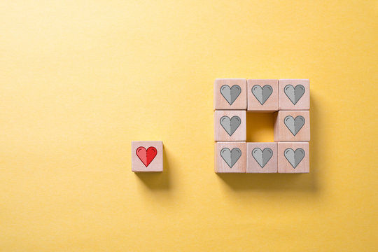 wooden blocks with heart icons on paper background