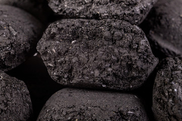 Wood briquette used for grilling meat. Pressed charcoal for smoking in the grill.