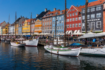 Fototapeta na wymiar Summertime in the fantastic city of Copenhagen. Iconic Nyhavn with its colorful houses and old boats