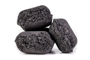 Wood briquette used for grilling meat. Pressed charcoal for smoking in the grill.