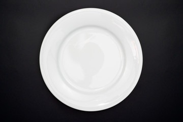Table setting. Empty plate on a black background. Top view and flat lay with copy space.
