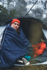 tourist traveler ralaxing in camp tent in foggy rain forest, closeup lonely hiker woman enjoy mist nature trip, green trekking tourism, rest vacation concept camping holiday, hiking campsite