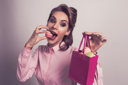 Woman eating macaroons
