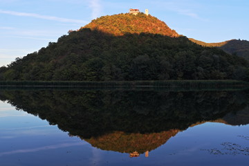 Beautiful mountain monastery river reflection.
