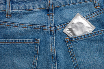 Close up view of condom in blue jeans pocket