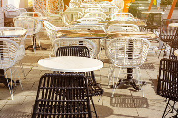 Veranda of an outdoor cafe with empty tables