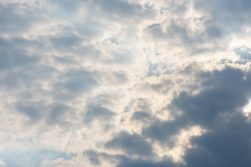 landscape sky with blue clouds and sunbeams at sunset. Background texture