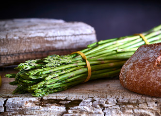 Fresh green asparagus on wooden table background. Healthy lifestyle concept.