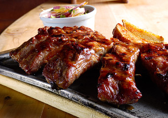 Typical Colombian dish, ribs with sauce, arepa, french fries and salad