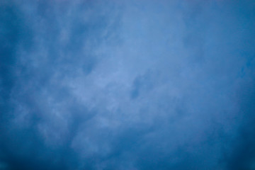 a dark blue sky with a cloud background