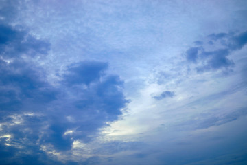 Dark blue and white cloudy with blue sky background.