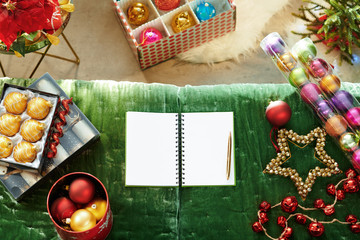 opened notebook with blank pages laying near Christmas ornaments