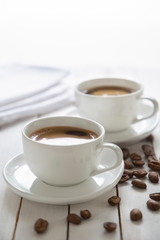 cup of coffee and beans on wooden table