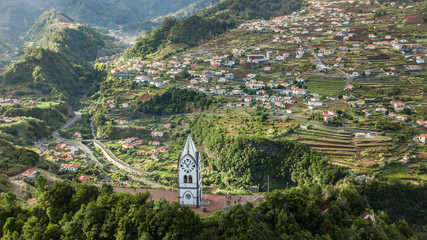 Aerial view of "Nossa Senhora de Fatima" old chapel tower with "Sao Vicente" village as background, Madeira island, Portugal.