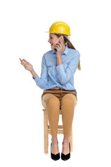 happy young woman wearing safety helmet and looking to side