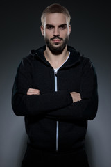 young fashion model wearing gym suit and crossing arms