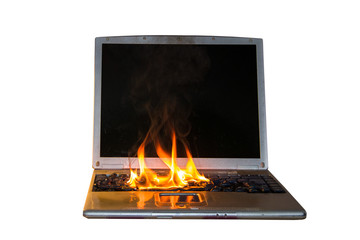 Burning laptop and keyboard, equipment fire due to faulty battery and wiring. On a white background, isolate.