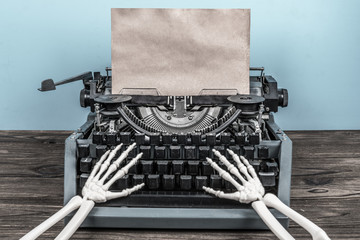 Skeleton hands print on old vintage typewriter