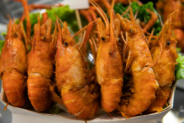 Fried king shrimps seafood by fire and BBQ Flames. Restaurant Barbecue at the night market.