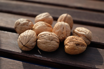 Walnuts in shell on wooden table