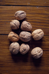 Walnuts in shell on wooden table
