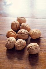Walnuts in shell on wooden table
