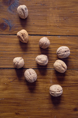 Walnuts in shell on wooden table