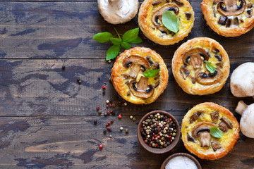 Tartlets with mushrooms and chicken on a wooden background. View from above.