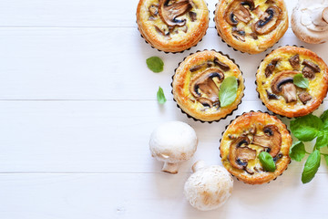 Tartlets with mushrooms and chicken on a wooden background. View from above.