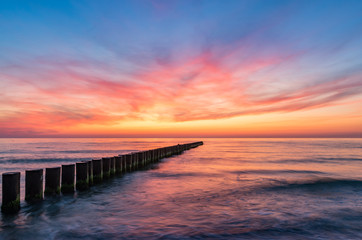 Fototapeta na wymiar Baltic sea seascape at sunset, Poland, wooden breakwater and waves