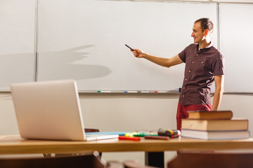 Male teacher listening to students at adult education class