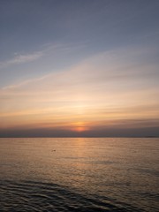 Serene seascape of Crimea. Sun descending into quiet sea
