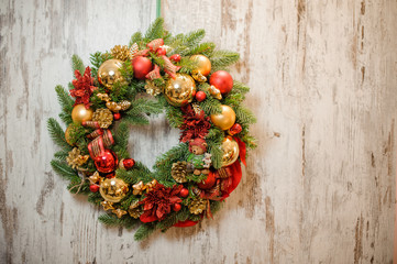 Christmas green artificial wreath with golden and red decoration toys