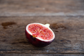 Figs cut in half on an old rustic table.