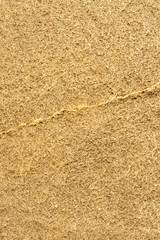 Gold rough stone texture closeup vertical background, copy space background