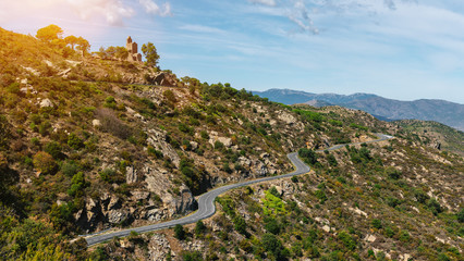 Fototapeta na wymiar Mediterranean sea coast road into mountains horizon in summer with beautiful bright sun rays