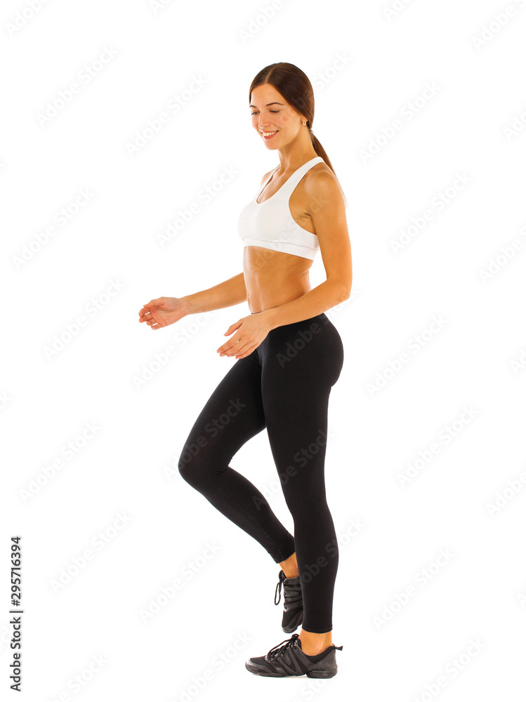 Wall mural young healthy girl doing exercises, full length portrait isolated over white background